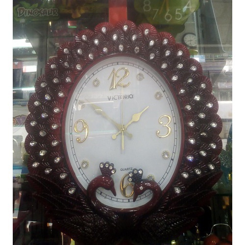 Peacock shaped maroon wall clock